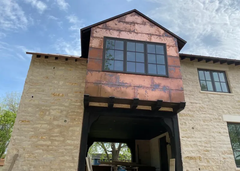 Copper metal panel facade on a stone building for Skylight Installation in Latrobe